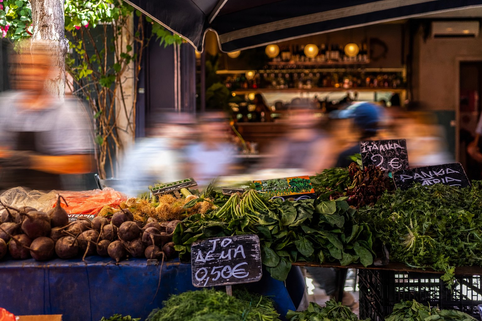 A greengrocer's stall at the Kallidromiou Street market, beetroot, wild greens and handwritten price boards